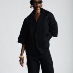 The Dune Jacket embodies the balance of strength and ease — a cropped, boxy silhouette cut with precision, its surface echoing the shifting calm of desert sands. In Sand and Shadow, it stands as a study in presence: effortless, architectural, and timeless in its authority.